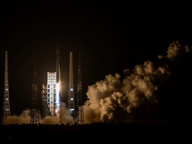 Nighttime launch of the Long March 12 rocket from the Wenchang Commercial Space Launch Site, illuminating the sky with bright flames and plumes of smoke