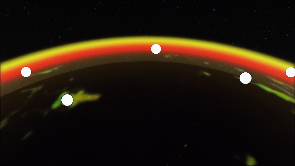 a red, yellow and orange arc crosses a black field. Six white dots along the arc represent satellites.