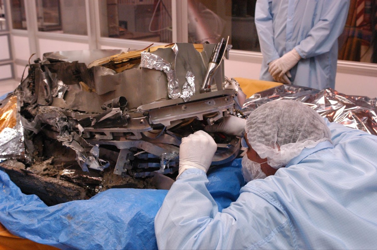 A damaged Genesis sample container undergoes close scrutiny as researchers salvage the mission’s scientific goals. Credit: NASA
