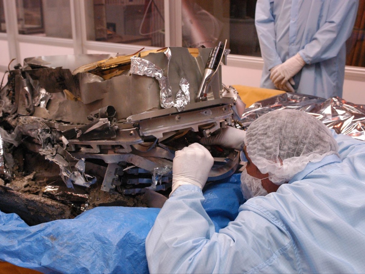 A damaged Genesis sample container undergoes close scrutiny as researchers salvage the mission’s scientific goals. Credit: NASA
