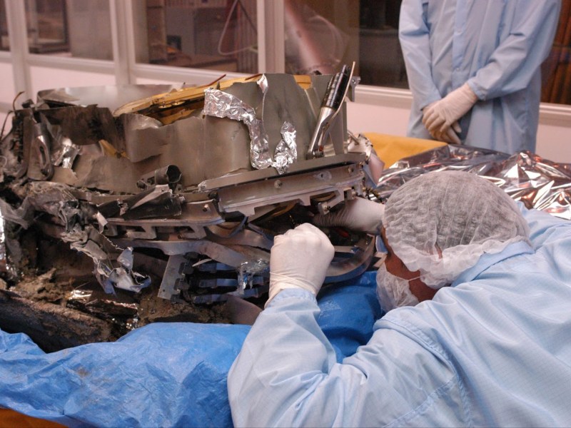 A damaged Genesis sample container undergoes close scrutiny as researchers salvage the mission’s scientific goals. Credit: NASA