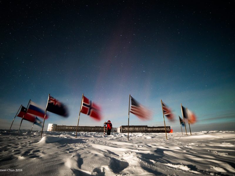 National flags raised during a ceremony at Amundsen-Scott South Pole Station. Image courtesy of Manwei Chan