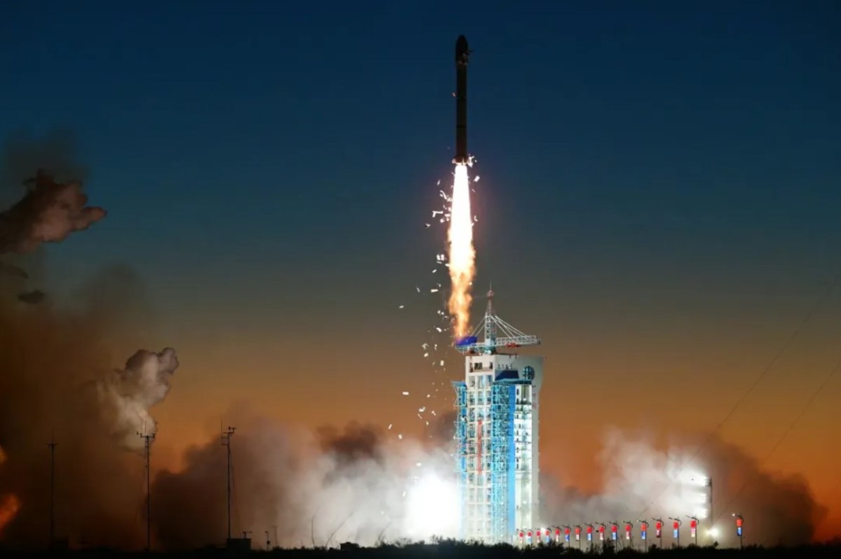 Long March 2C rocket carrying the SuperView Neo-2 03 and 04 satellites launches into the night sky from the Jiuquan Satellite Launch Center on November 24, 2024, with visible insulation tiles shedding from the upper stage during ascent.